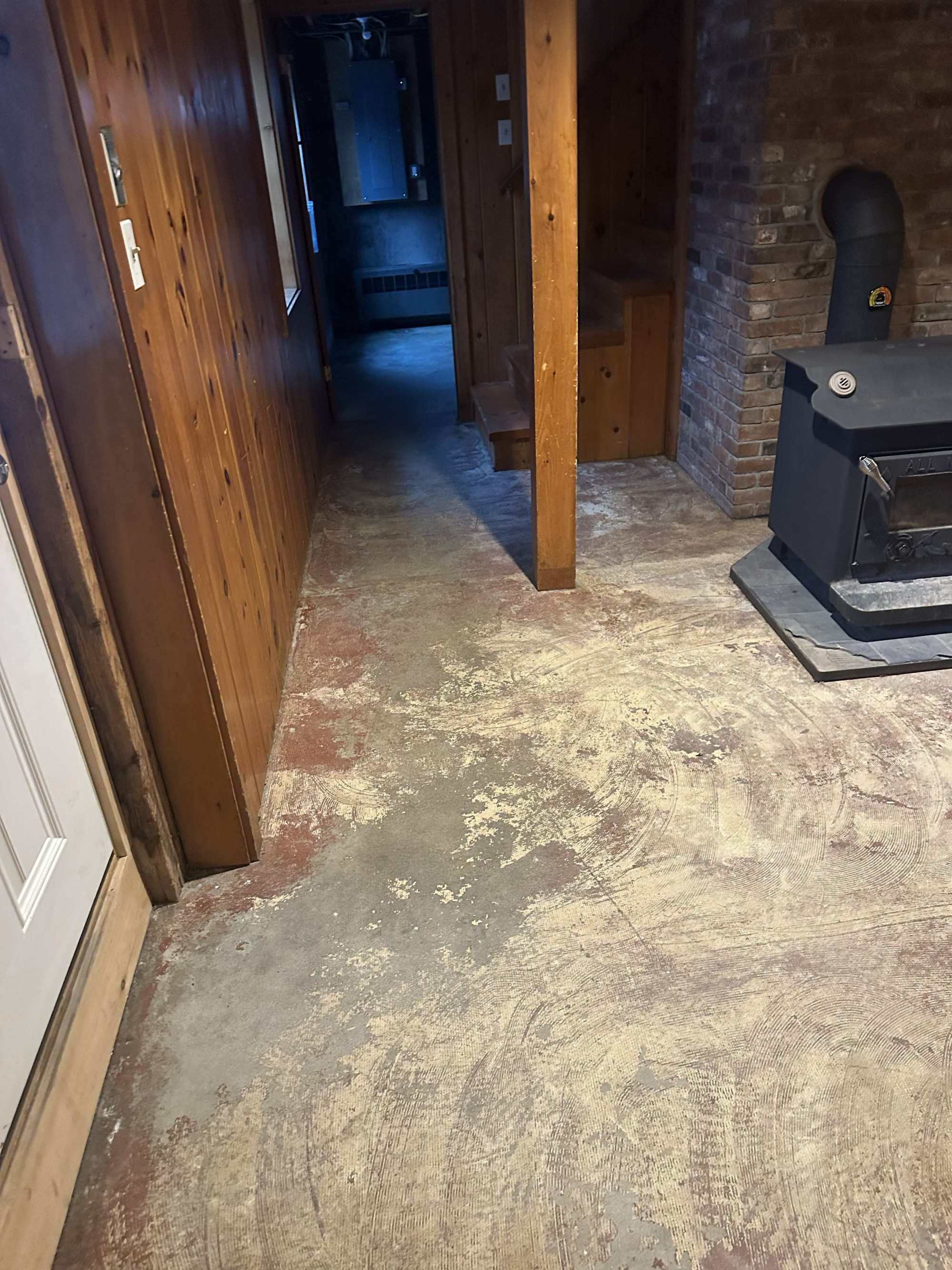 Garage floor before concrete coating - cracked and stained concrete